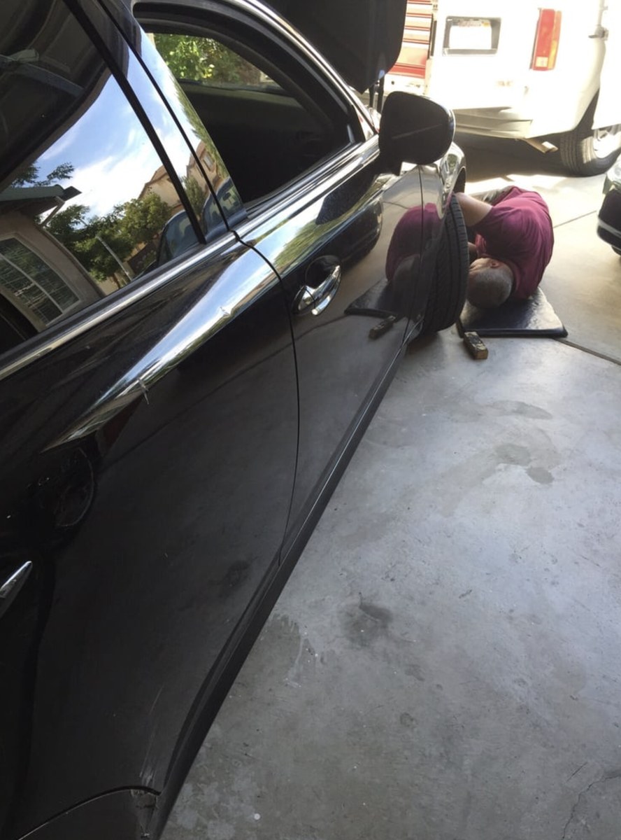 Las Vegas mobile mechanic working under a car at a home